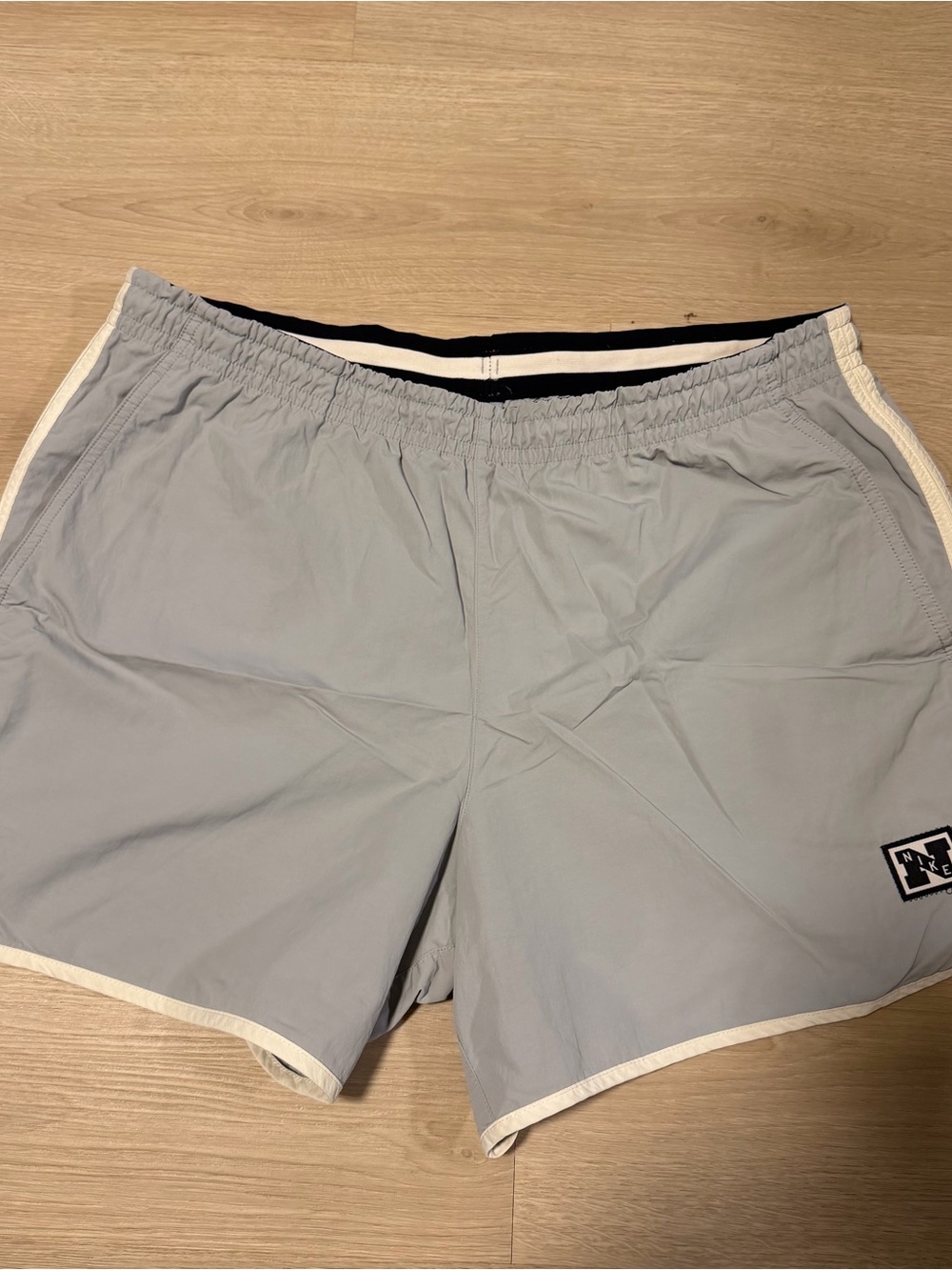 Nike Light Gray Men’s Athletic Shorts with White Trim & Logo Patch
